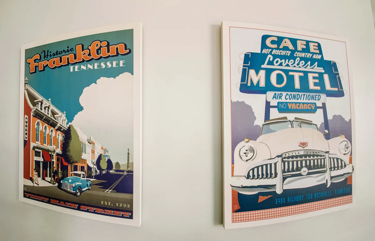 A cozy corner spotlighting a historic Franklin poster and an iconic Loveless Motel sign, evoking a sense of local discovery and neighborhood charm. The artwork hints at nearby destinations and the experience of exploring the area.